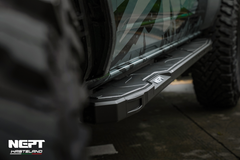 Close-up of a vehicle's side step with a brand logo in the corner.