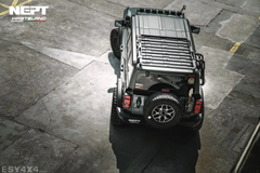 4x4 vehicle with a roof rack on a stone pavement, branded 'NEPT Wasteland'.