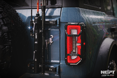 Close-up of a ford bronco rear with the NEPT Wasteland rear tail light cover and flag mount