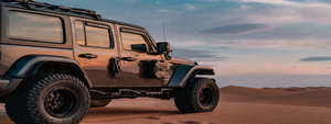 a black jeep wrangler in the desert. passenger side view with fury awaken jeep accessories