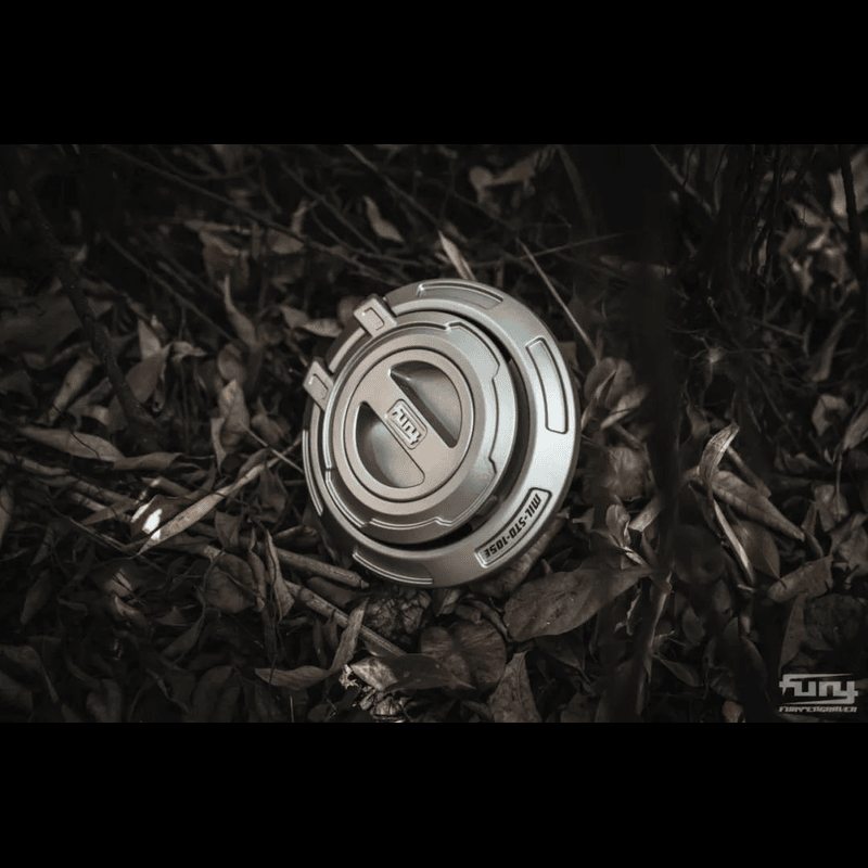 far view of silver jeep wrangler gas cover on the ground on leaves