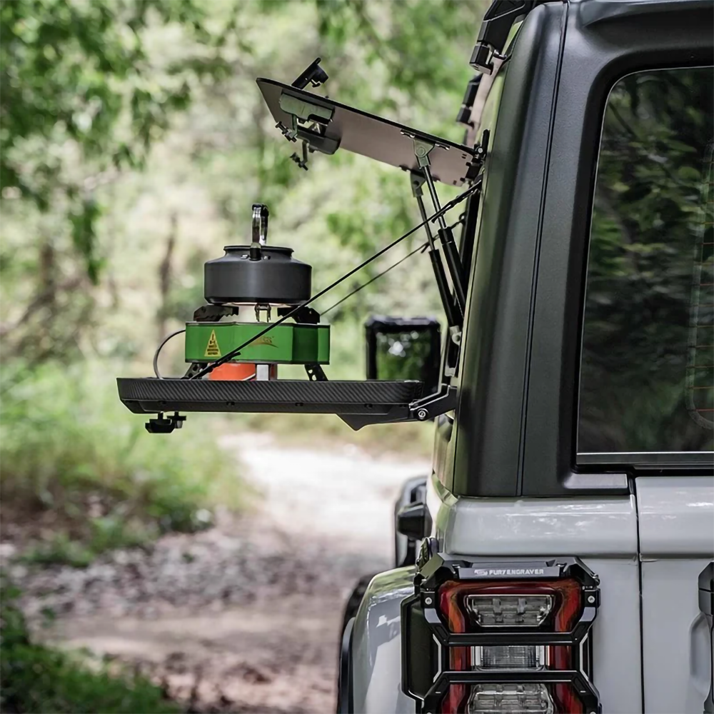 jeep 4xe side tool box from a rear view open using it as a table with gas stove