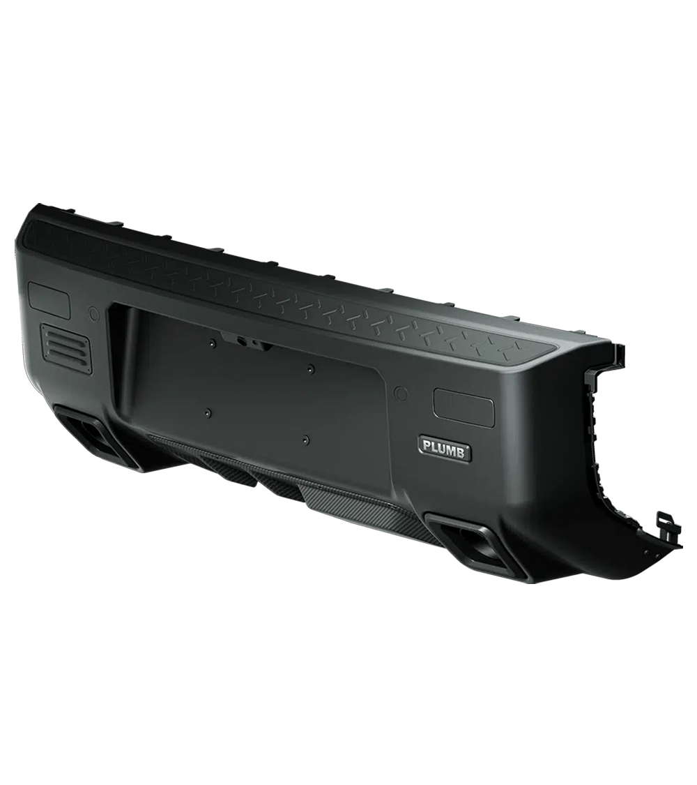 Close-up view of the PLUMB rear bumper installed on a Land Rover Defender, highlighting its rugged design and textured finish.