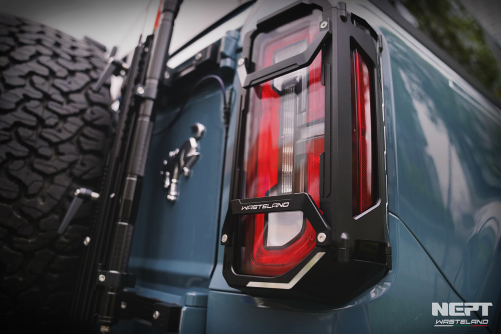 Close-up of a ford bronco tail light with 'Neft' branding on a blurred background
