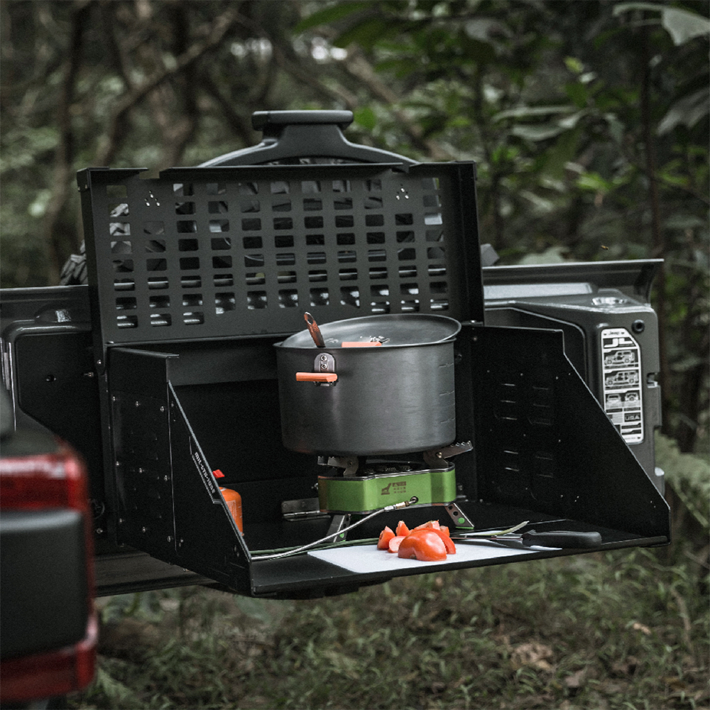 tailgate table front view black in color with gas stove and pot on the table with veggies