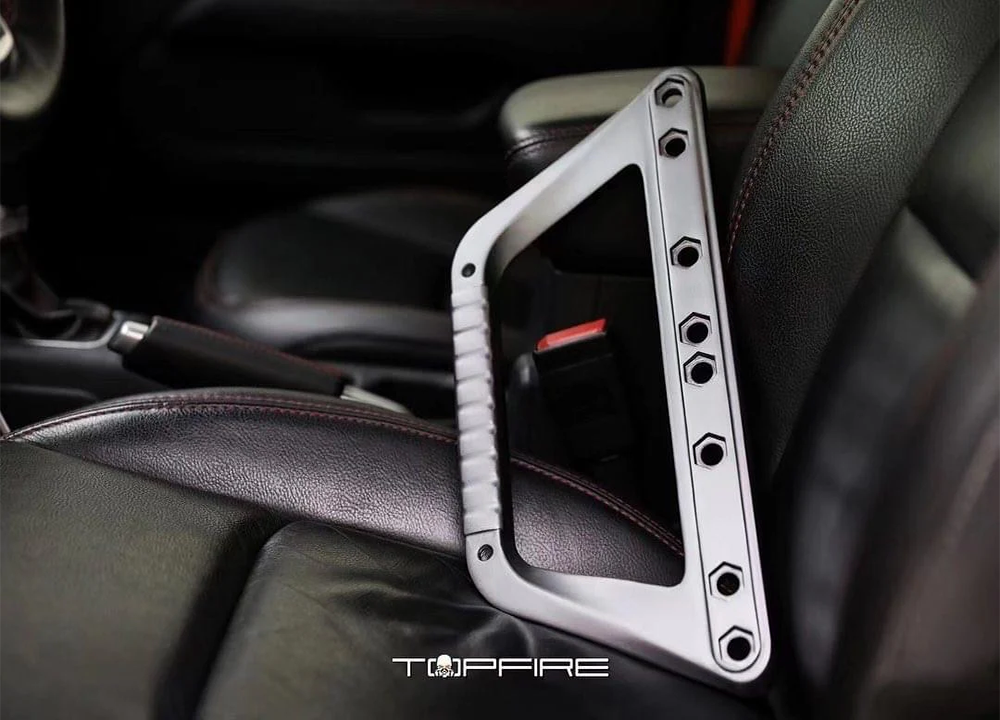 topfire jeep wrangler jl grab handles silver in color resting on front drivers seat